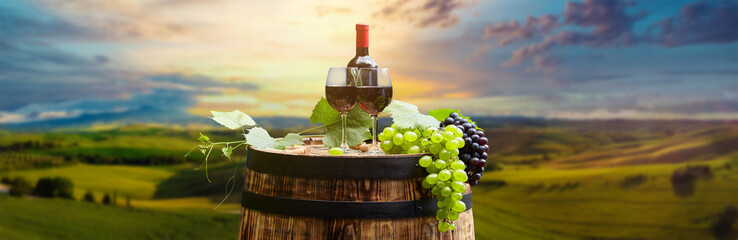 Fototapeta na wymiar red wine bottle and wine glass on wodden barrel