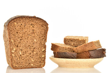 Slices of black cereal bread, close-up, on a white background.