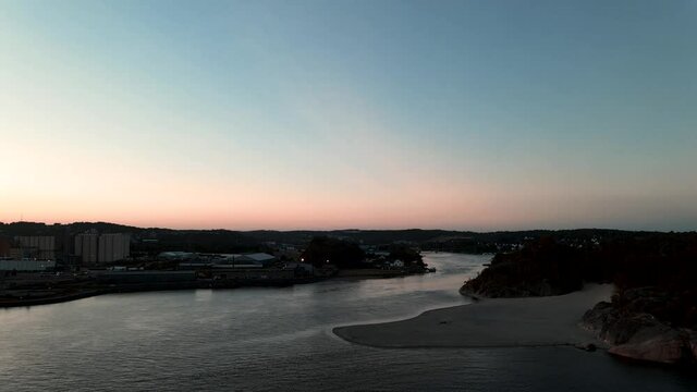 The river Logen pouring into the ocean in Larvik Norway during a beautiful sunset