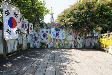 Flags and prayer ribbons tied to the fence as symbol for peace between North and South Korea at the...