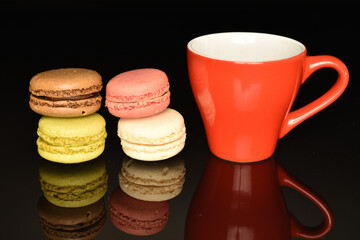 Tasty multi-colored, sweet macaroons, on a black background.