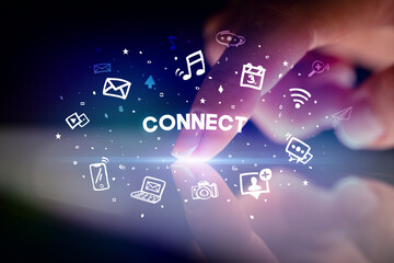 Finger touching tablet with drawn social media icons and CONNECT inscription, social networking concept