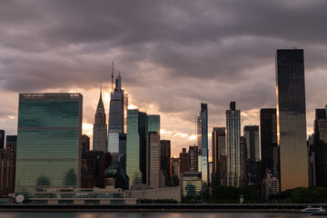 Fototapeta na wymiar Ominous Sky with the Midtown Manhattan Skyline during a Beautiful Sunset along the East River in New York City