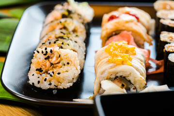 Sushi and roll set on wooden table. Selective focus