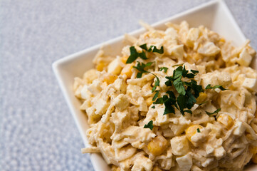 Bowl of vegetable salad of corn apples cellery and spices