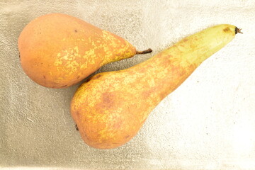 Ripe pears, close-up, on a metal tray.