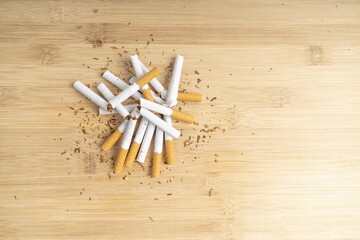 Top view of broken cigarettes on  a wooden board
