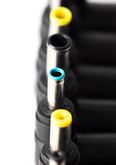 Plugs for charging a laptop on a white background