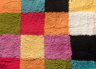 Old carpet with a square color ornament after washing in the sun