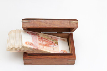 Russian banknotes of five thousand rubles in large quantities in a wooden box