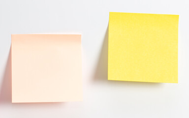 Colored papers hang on a white background.