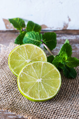 Lime with mint on rustic background