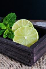 Lime with mint on rustic background