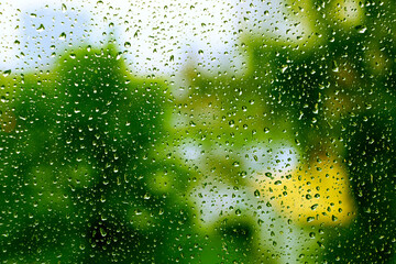 Texture of water drops. Drops of water on glass on a green background.