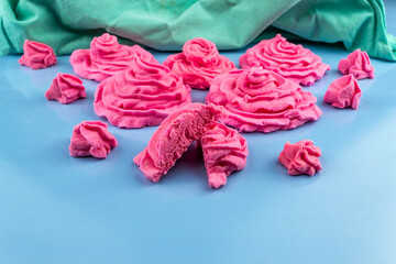 Pink marshmallows on a blue background