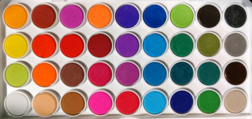 A new box with multi-colored paints for drawing in top view