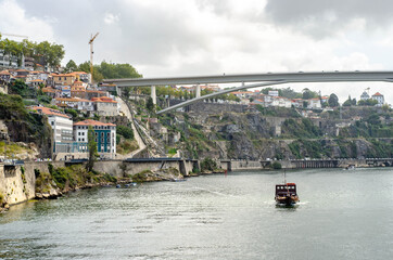 Naklejka premium Ponte do Infante bridge in Porto Portugal. Old historic houses on a hill