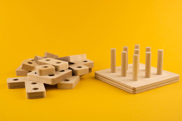 Children's wooden toy sorter. Educational logic toys for kid's close-up. Montessori Games for child development blur