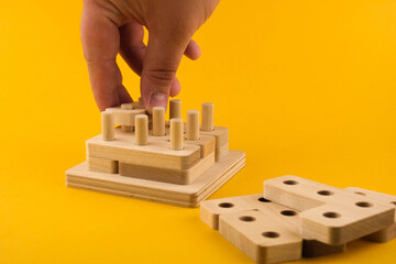 Children's wooden toy sorter. Educational logic toys for kid's close-up. Montessori Games for child development blur