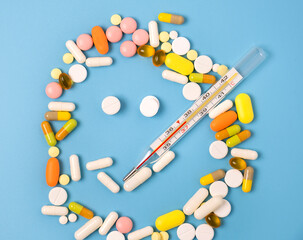 Close up of many different pills on blue background.
