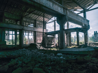 Soviet ruins of the plant. The abandoned building was overgrown with greenery and collapsed.