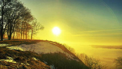 Fototapeta na wymiar morning spring fog over the river rises the sun is melting snow beautiful scenery