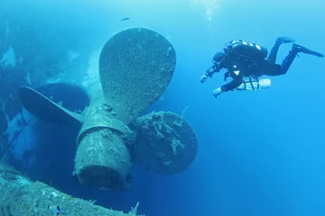 Papier Peint photo Naufrage Scuba divers explores propeller of sunken shipwreck Zenobia, Cyprus.