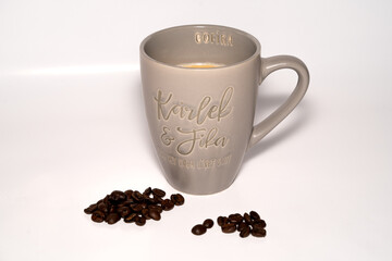 cup of coffee with beans on a white background