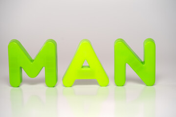 Green letters on white background spelling MAN