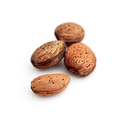 A pile of wild peeled almond nuts, closeup, isolated on white background.