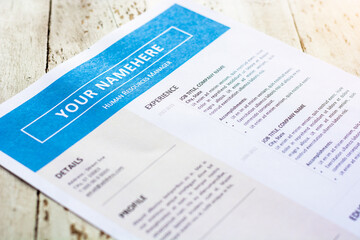 Template of resume on white paper with blue theme. Focus on experience title and blurred other titles.