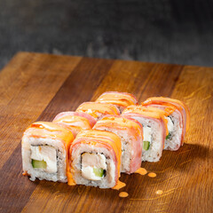 Japanese cuisine. Seafood, vegetables and meat. Sushi and rolls big set isolation on a wooden table background