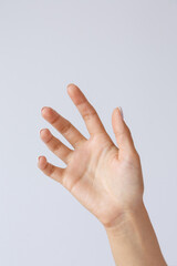 Gesture and symbol. Female hand holds or shows a smartphone. Hand for advertising smartphones