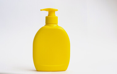 Shower gel, liquid soap plastic bottle of yellow color with a place for the text.