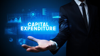 Hand of Businessman holding CAPITAL EXPENDITURE inscription, business success concept