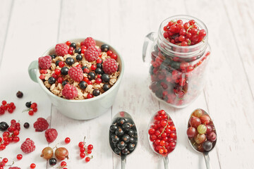 Colorful fresh berries on white background. Oatmeal with berries currants, raspberries, gooseberries. Vitamins, Diet. Copy space. Healthly food, detox. Cozy good morning! Summer Healthy breakfast