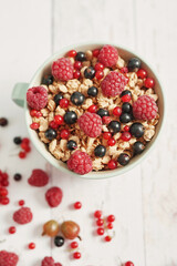 Colorful fresh berries on white background. Oatmeal with berries currants, raspberries, gooseberries. Vitamins, Diet. Copy space. Healthly food, detox. Cozy good morning! Summer Healthy breakfast