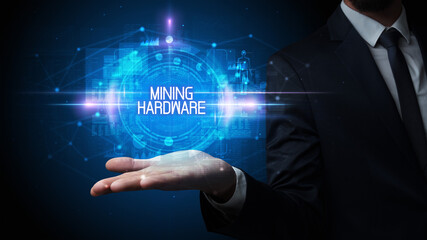 Man hand holding MINING HARDWARE inscription, technology concept