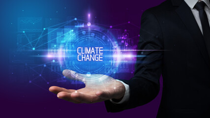 Man hand holding CLIMATE CHANGE inscription, technology concept