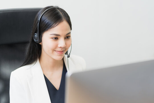 Young business asian woman working call centre customer service agents. Business female support operator with computer and headset in office.