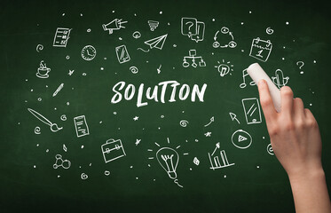 Hand drawing SOLUTION inscription with white chalk on blackboard, education concept
