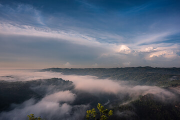 Cloudy blue sky background in foggy misty valley in Java Island, Indonesia