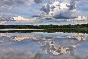 Beautiful clouds reflected on the blue lake surface