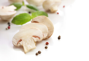 White champignons on white background. Close up