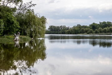 Beautiful clouds reflected on the blue lake surface