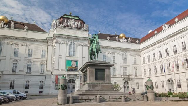 Equestrian statue of Holy Roman Emperor Joseph II riding a horse in Josefsplatz Square timelapse hyperlapse, Hofburg Palace in Vienna, Austria. Austrian National Library on a background