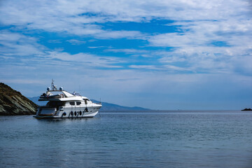 Fototapeta na wymiar Luxury yacht moored in the middle of the blue calm sea. Kea, Otzias, Greece.