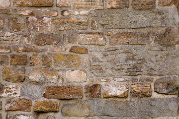 Grunge ancient brick stone wall of light beige color. Abstract texture or background.