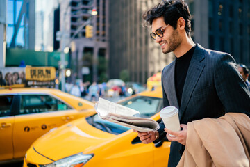 Trendy dressed investor in stylish clothing reading business news about corporate merger of...