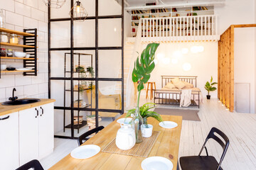 luxury modern design of a cozy small Scandinavian-style studio apartment with white walls, second floor with a library and huge high window full of day light